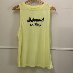 Yellow sleeveless shirt new without tags.